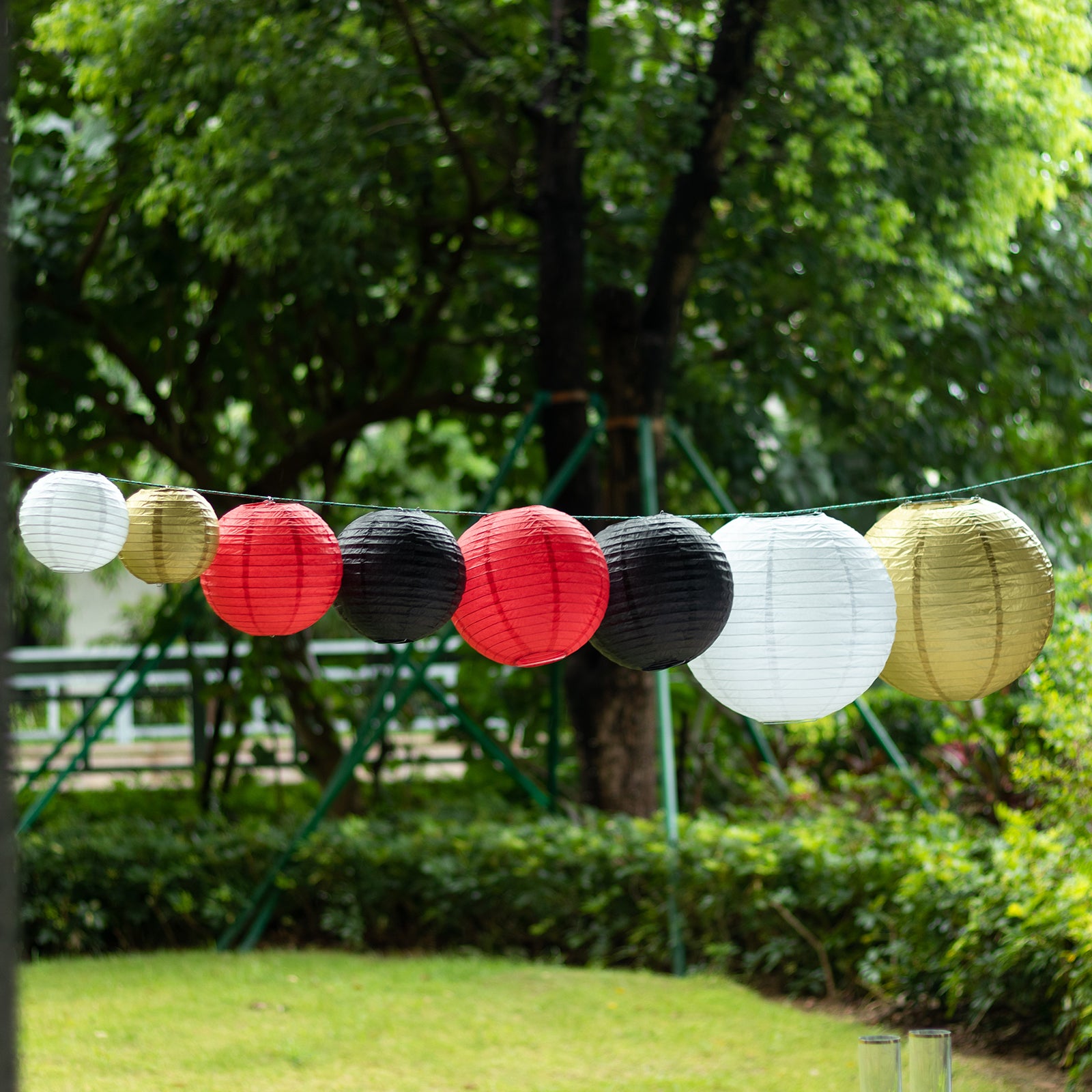 Set of 8 red and gold decorative hanging paper lanterns.