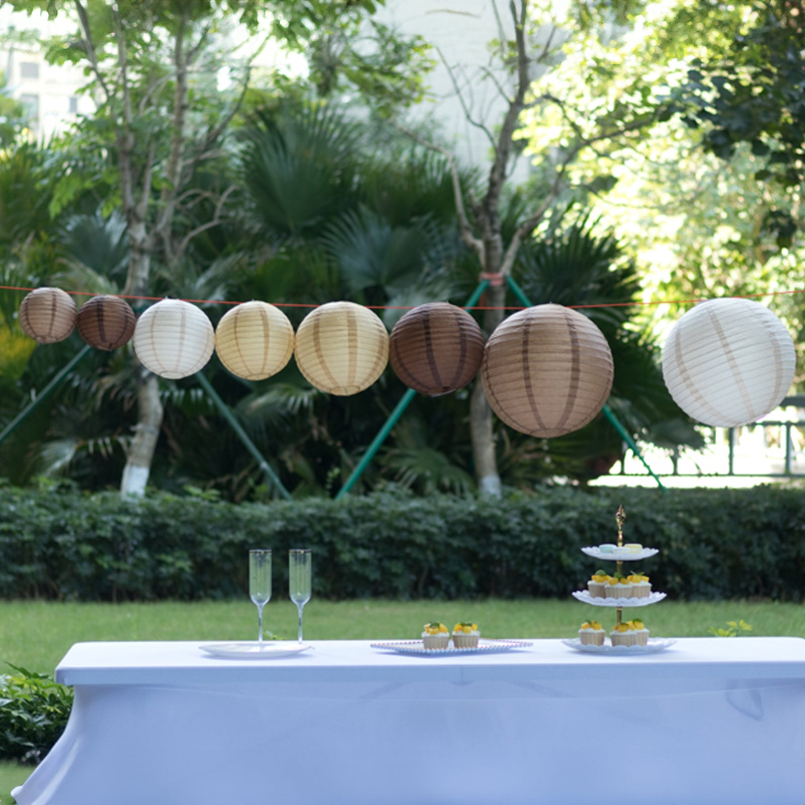 Natural brown hanging paper lanterns in assorted sizes, decorative for events.