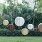 Set of 8 natural brown decorative paper lanterns in assorted sizes.