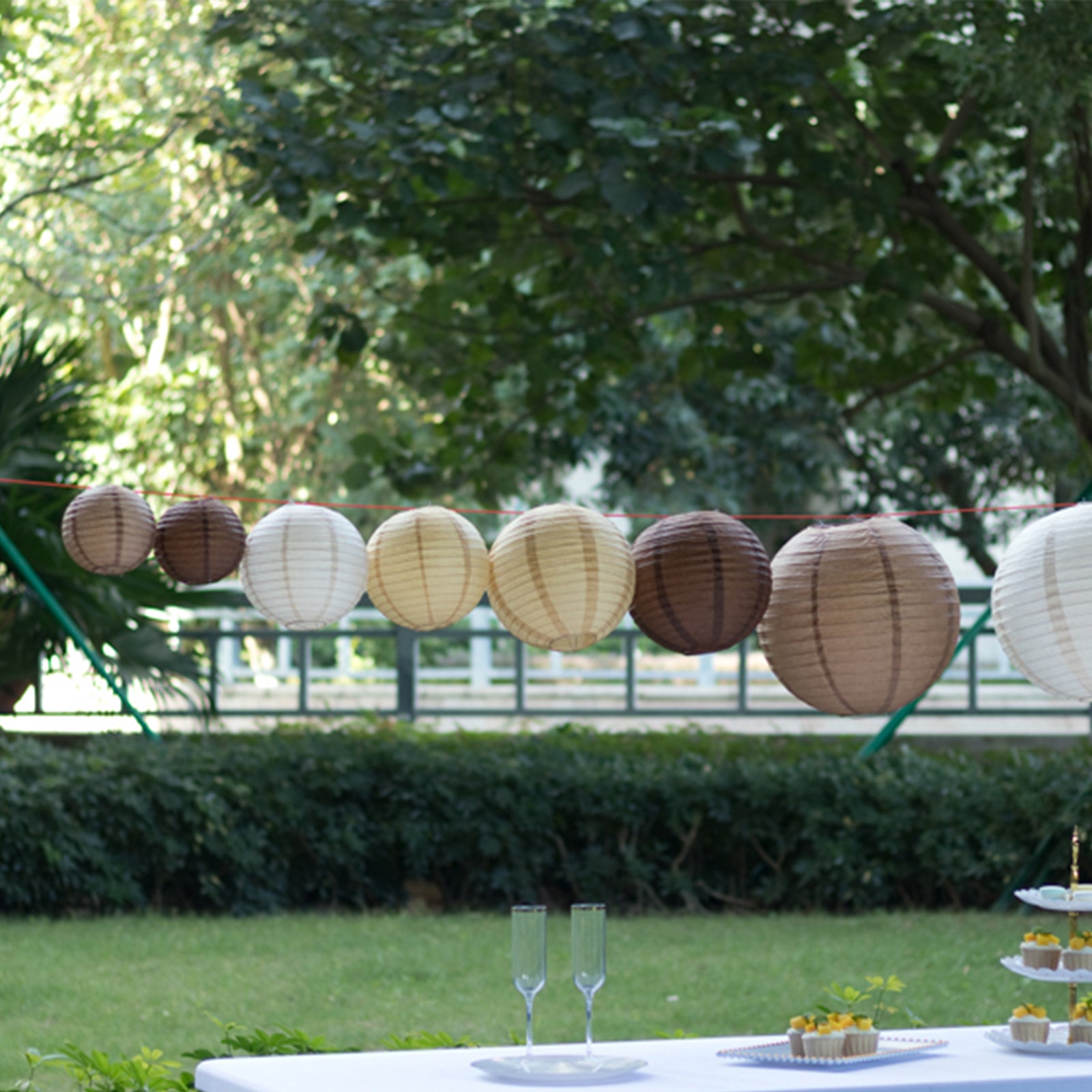 Natural brown hanging paper lanterns in assorted sizes.