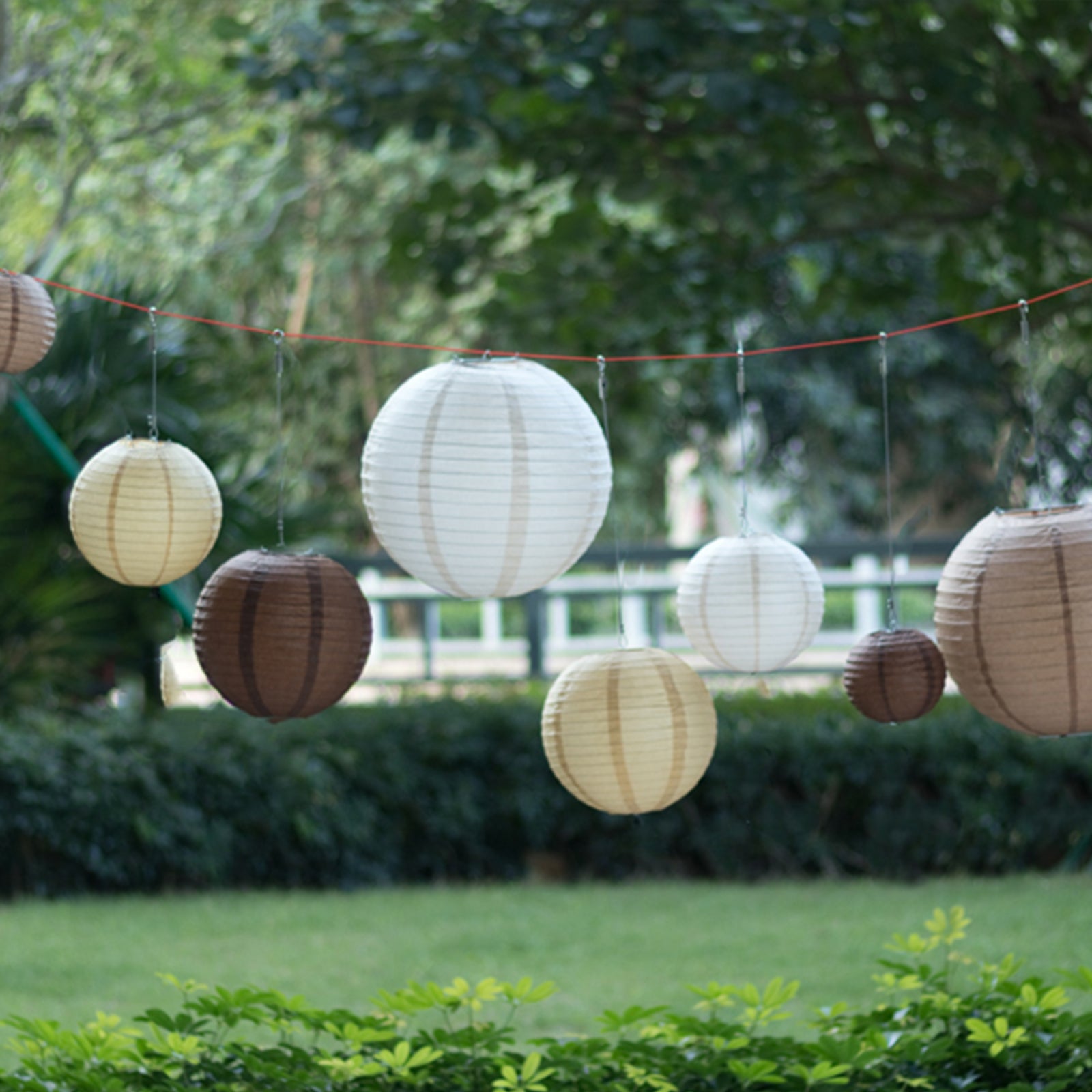 Natural brown hanging paper lanterns in assorted sizes.