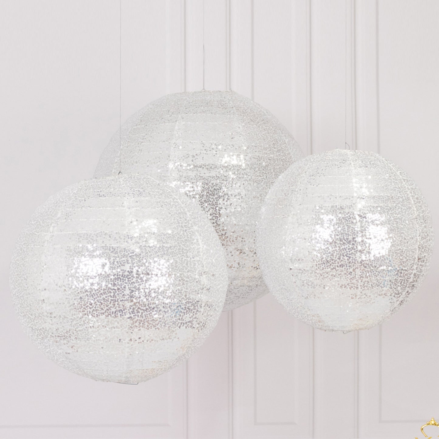 Glitter silver sequin fabric hanging lanterns in three sizes.
