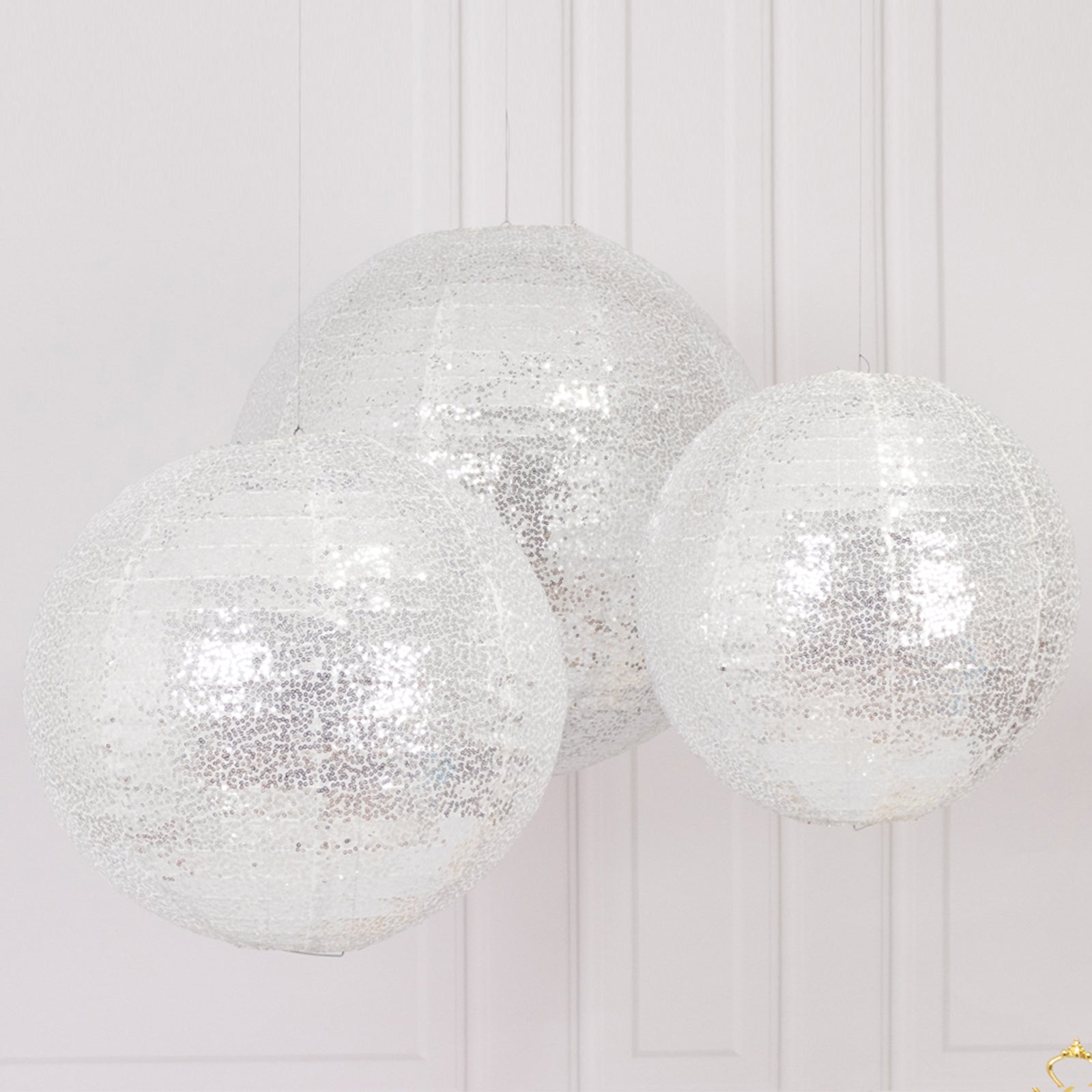 Glitter silver sequin fabric hanging lanterns in three sizes.