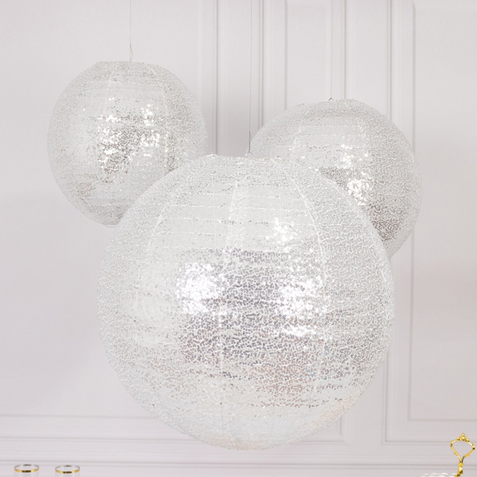 Glitter silver sequin fabric hanging lanterns in large round shapes.