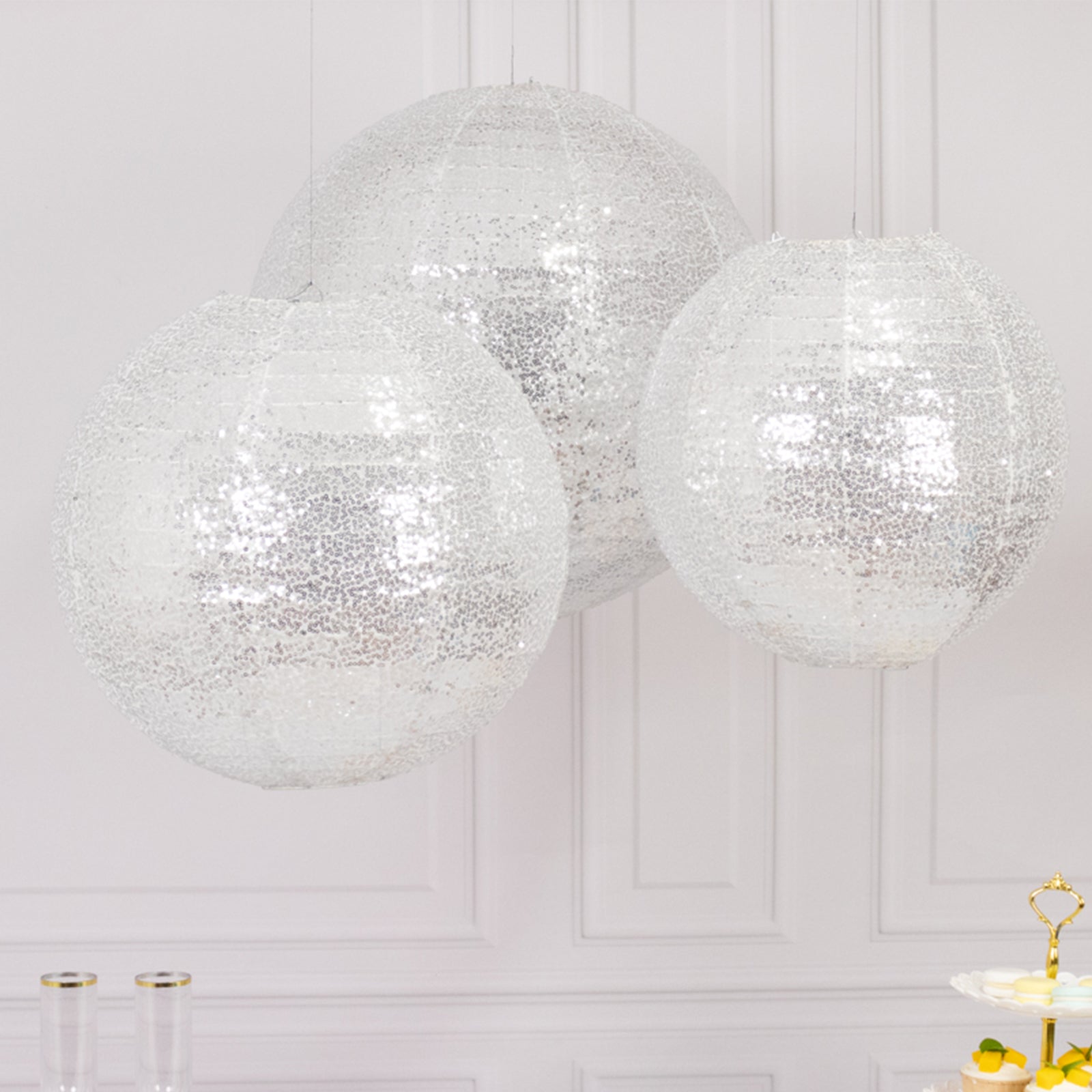 Glitter silver sequin fabric hanging lanterns in three sizes: 14", 16", and 20".