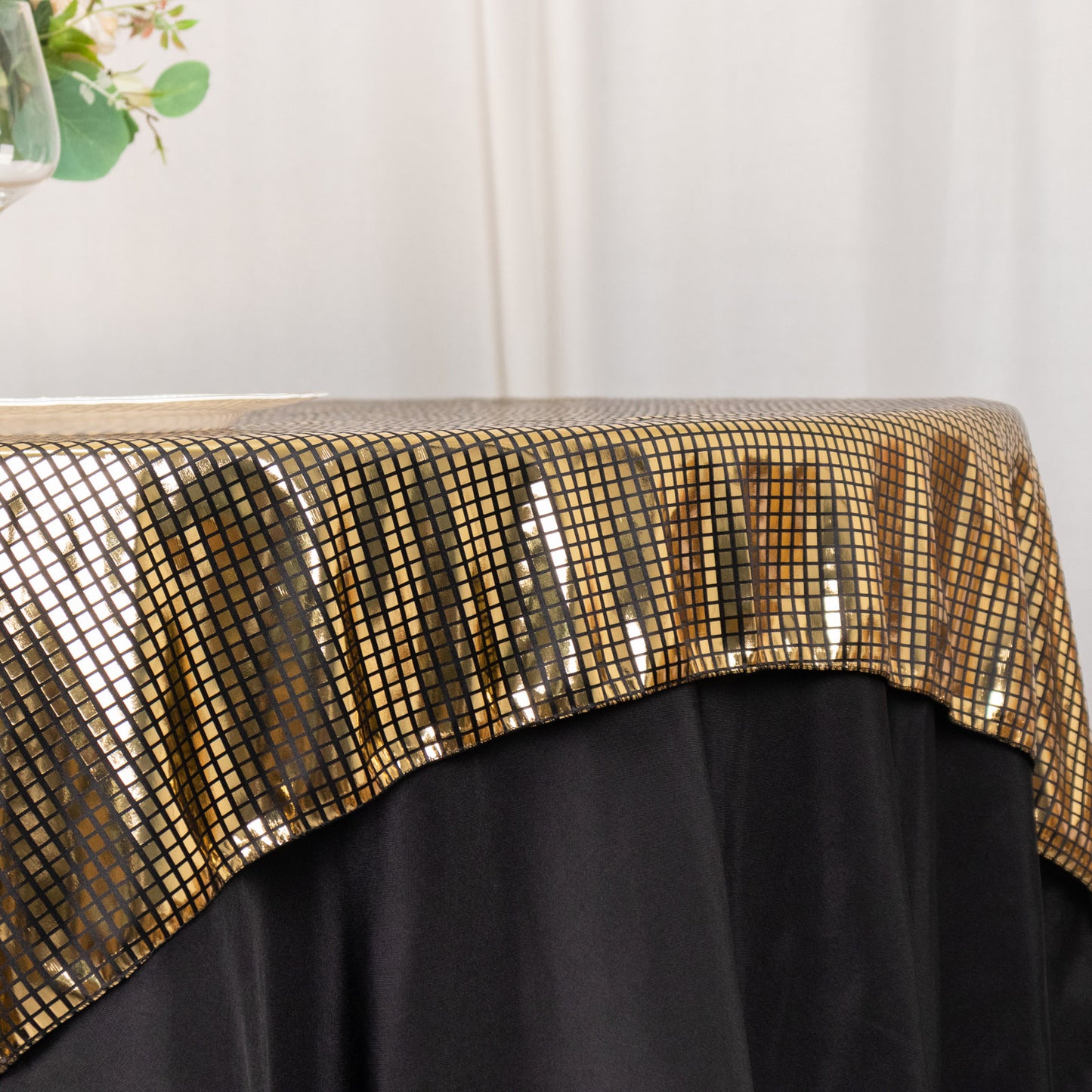 Shiny black gold foil table overlay with disco mirror ball theme.