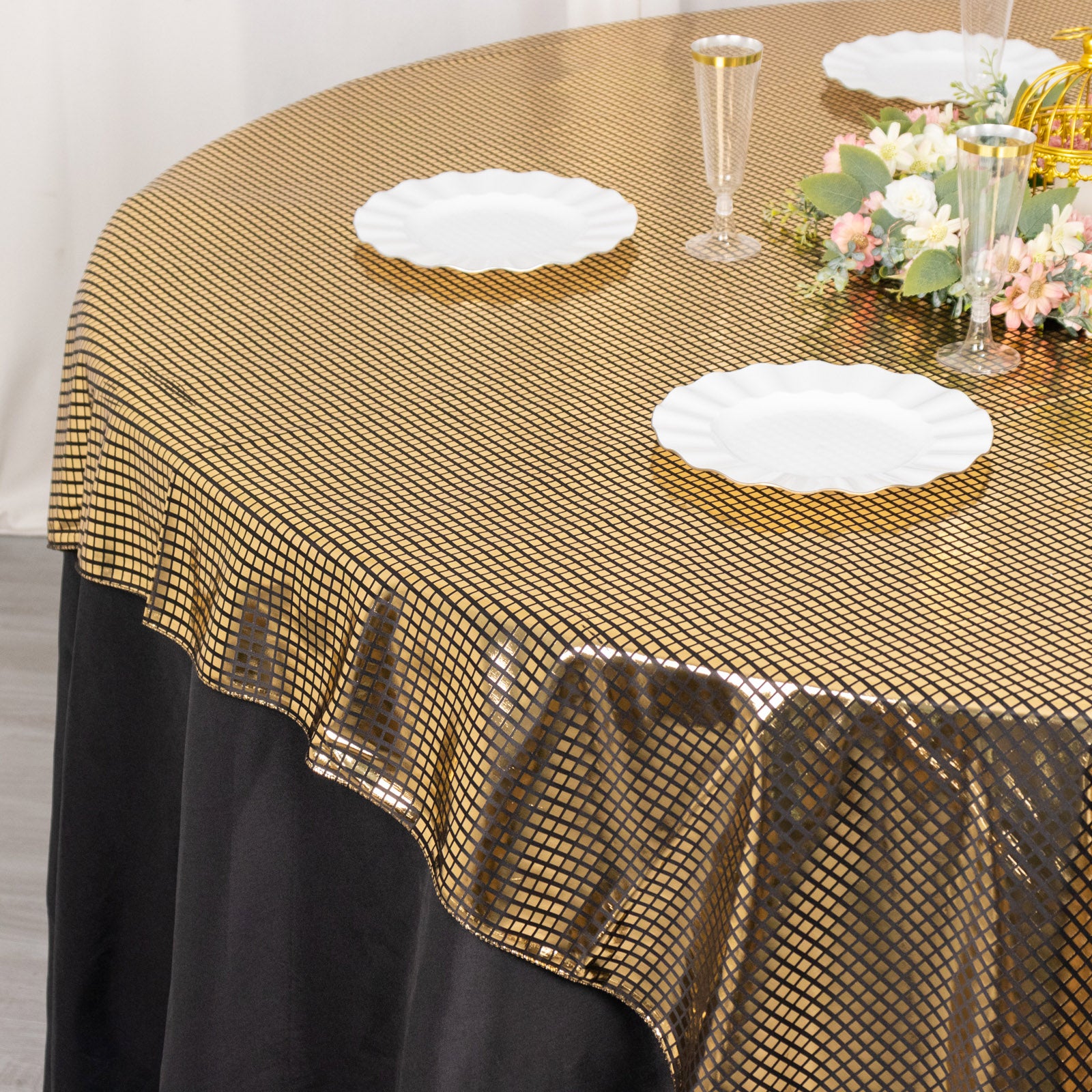 Shiny black gold foil polyester table overlay for disco mirror ball theme.