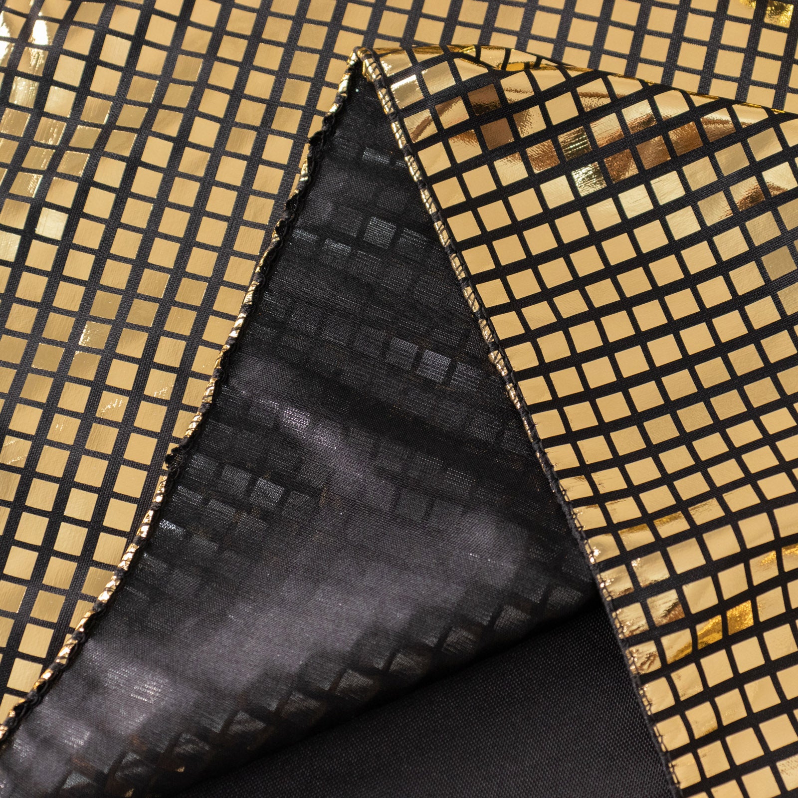 Shiny black and gold foil table overlay for disco theme events.