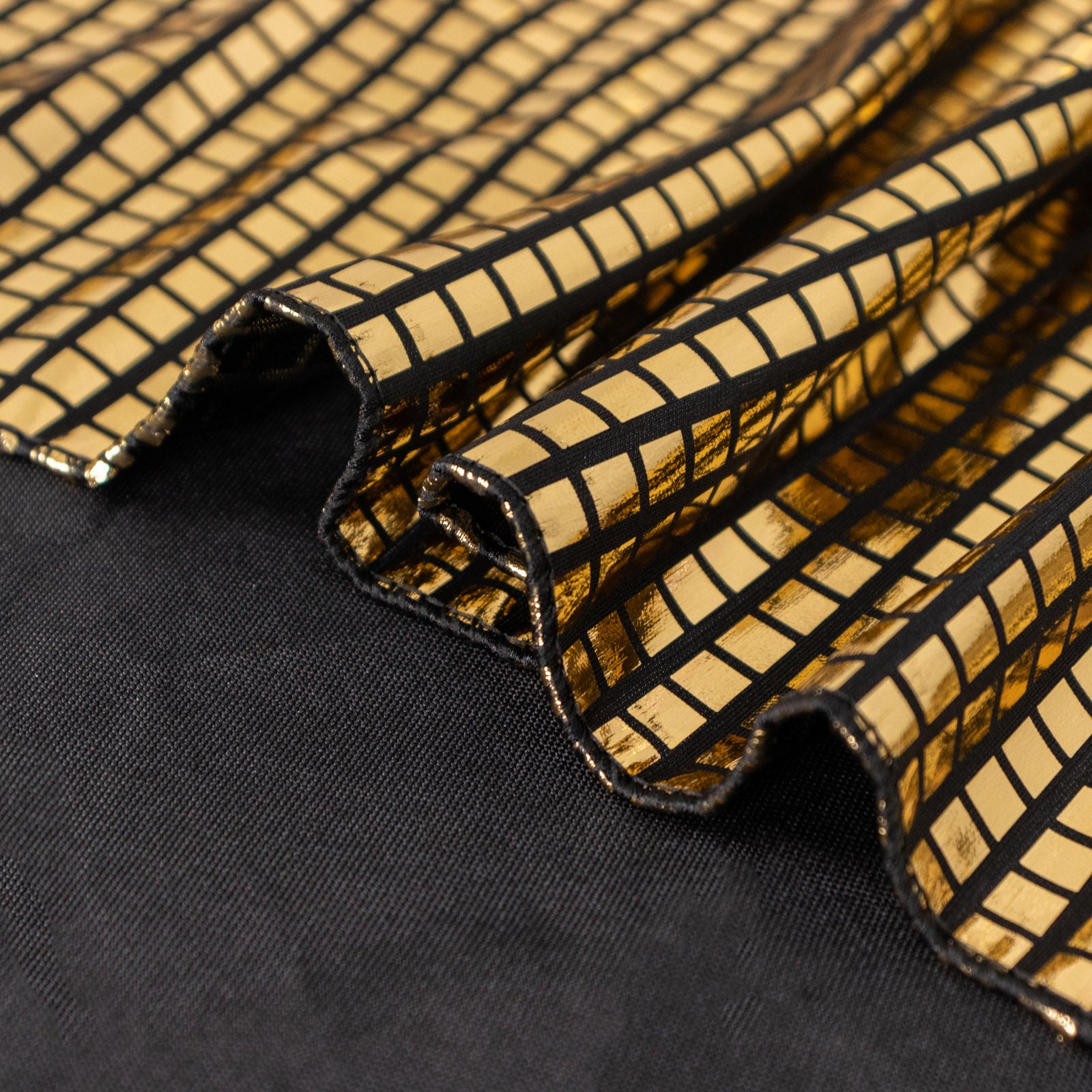 Shiny black gold foil polyester table overlay with disco mirror ball design.