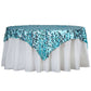 Turquoise sequin table overlay on a white tablecloth.