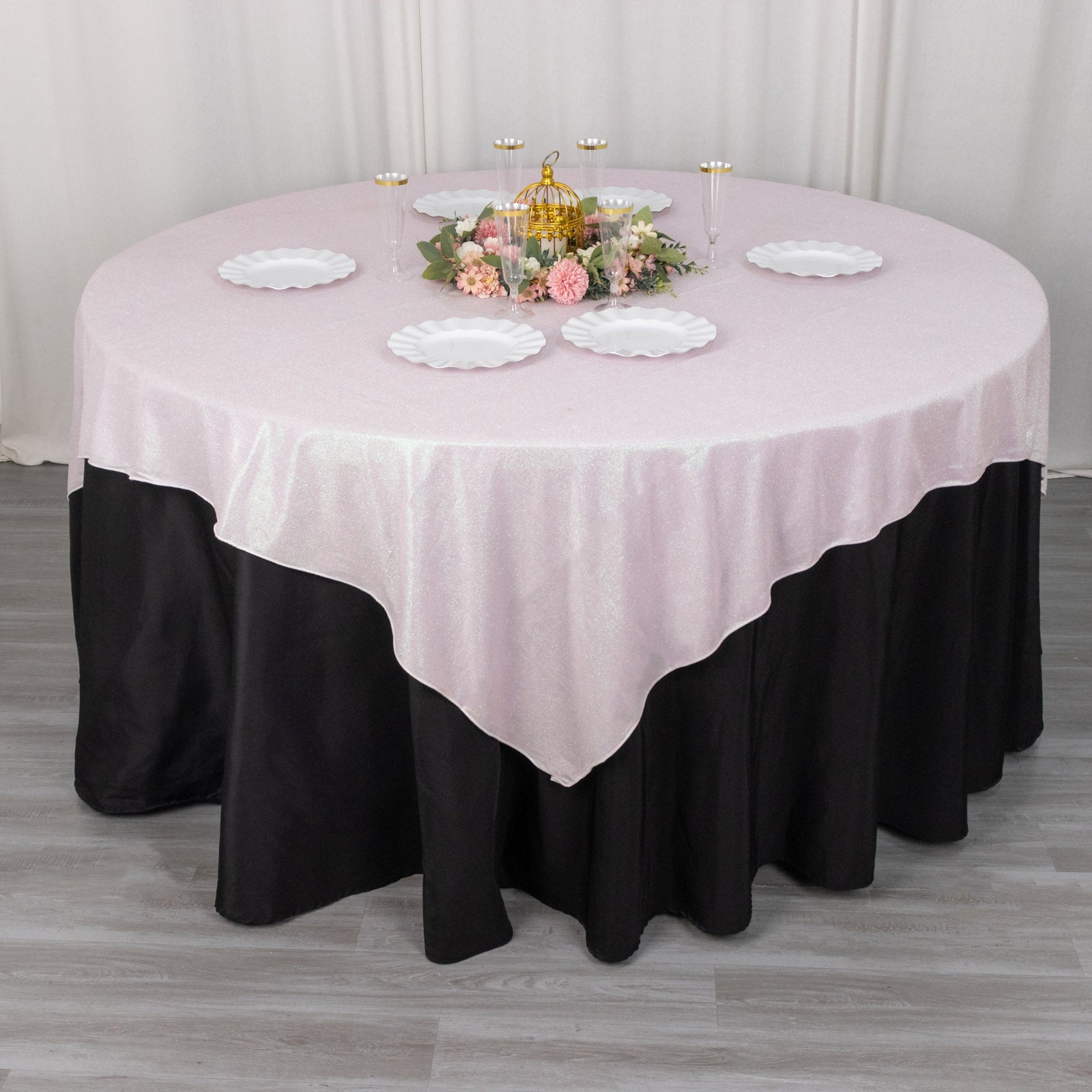 Iridescent glitter sparkle table overlay in soft pink with black accents.