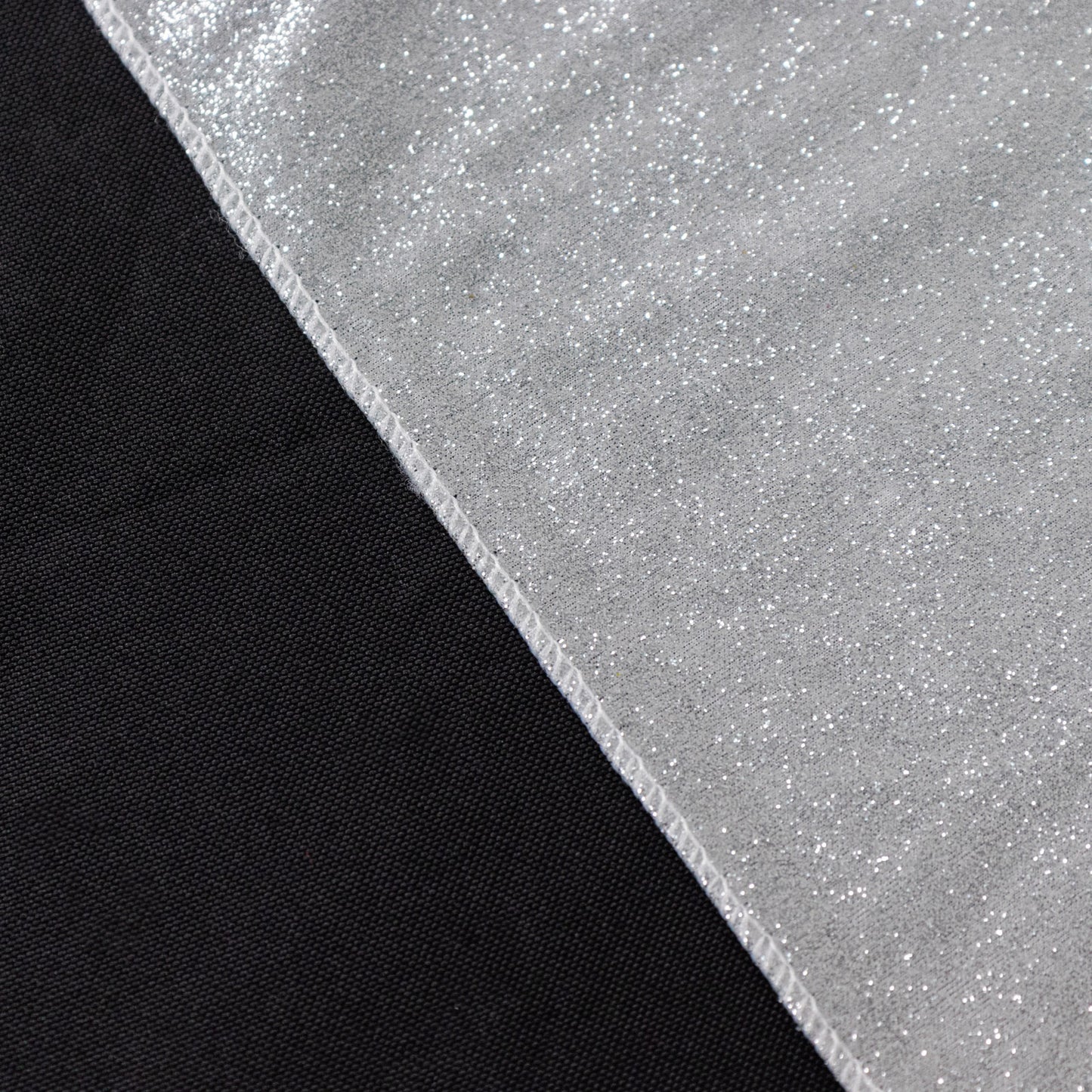 Silver glitter table overlay on a black table surface.