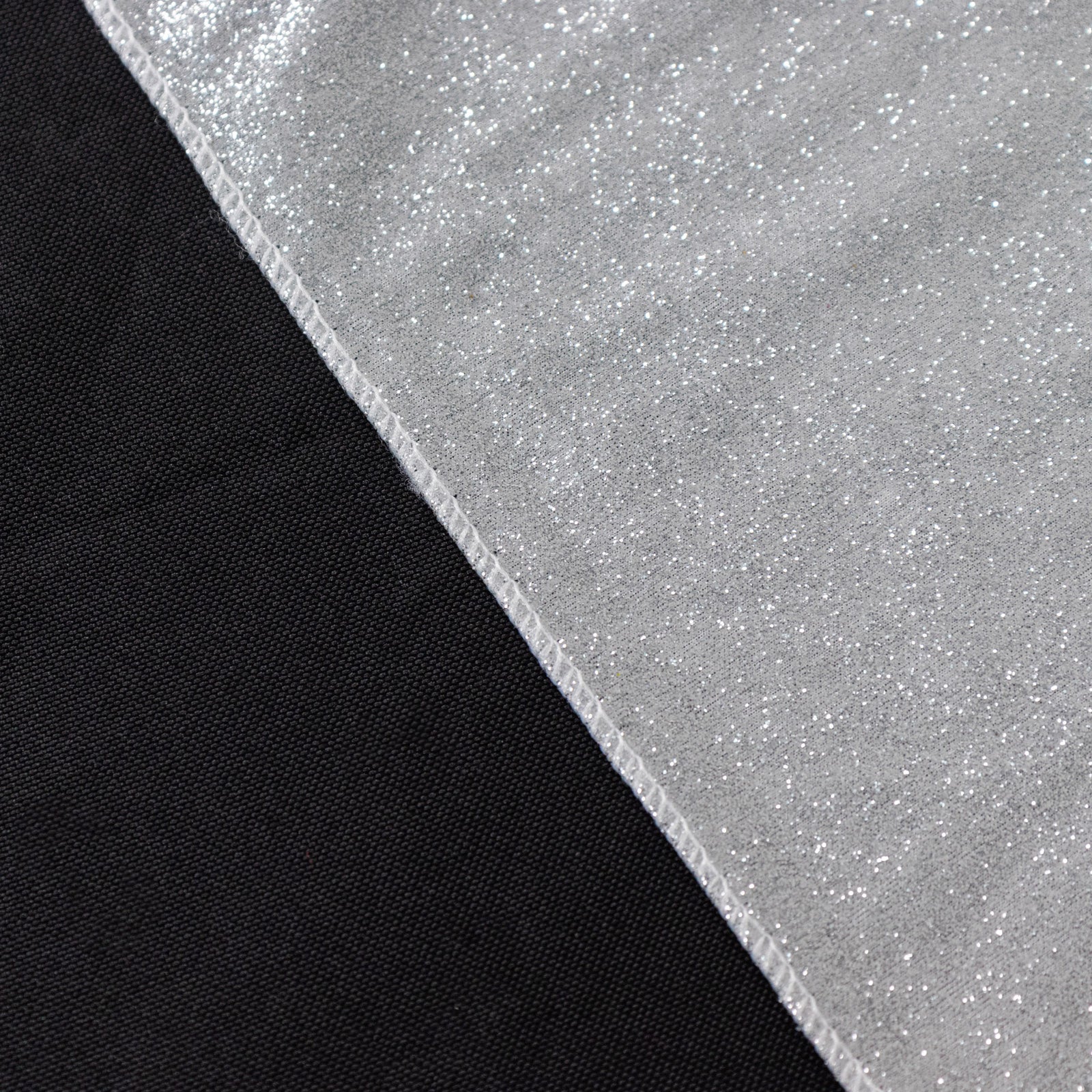 Silver glitter table overlay on a black table surface.
