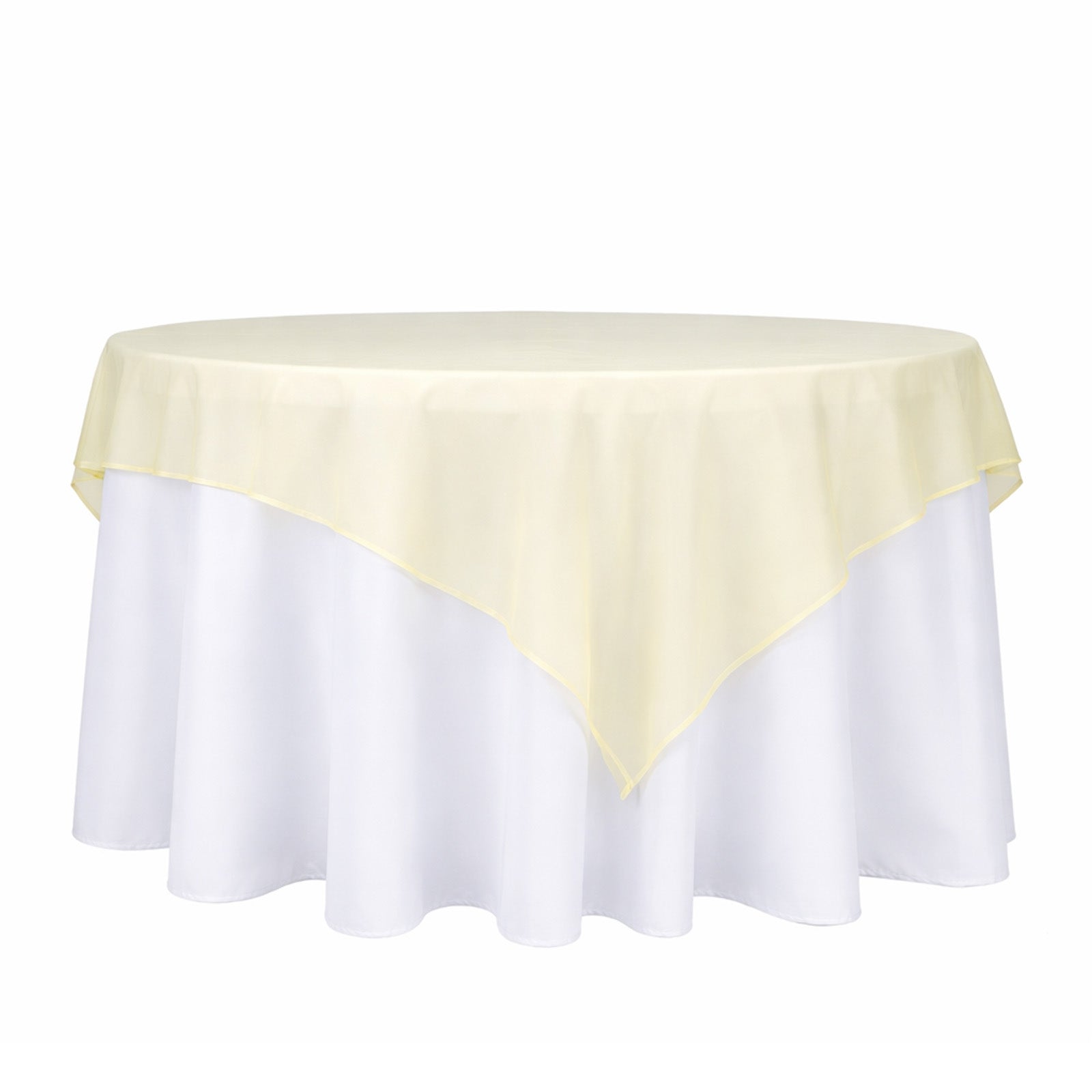 Champagne sheer table overlay on a white tablecloth.