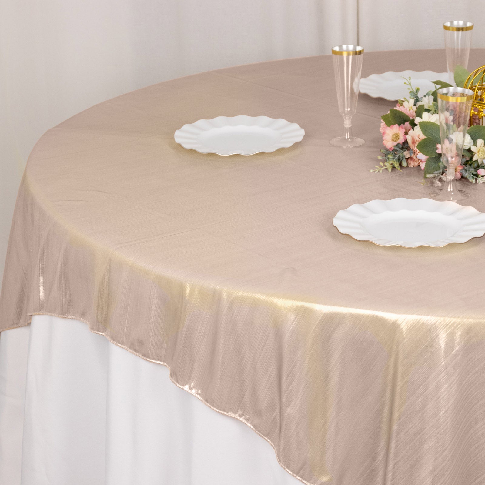 Blush shimmer sequin dots square table overlay on a round table.