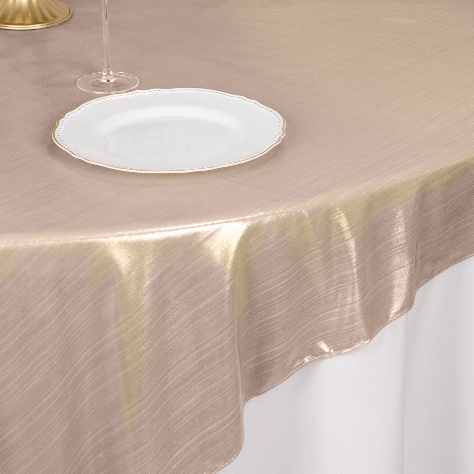 Blush shimmer sequin dots table overlay on a beige table setting.
