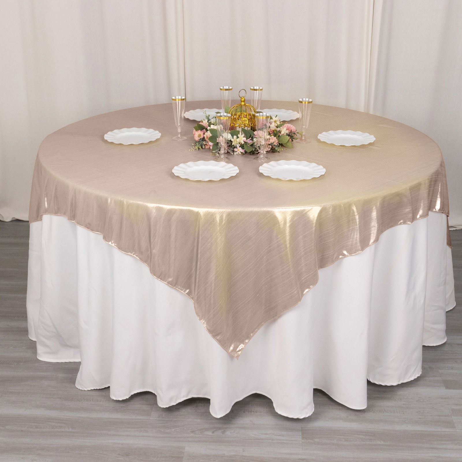 Blush shimmer sequin table overlay on a round table setting.