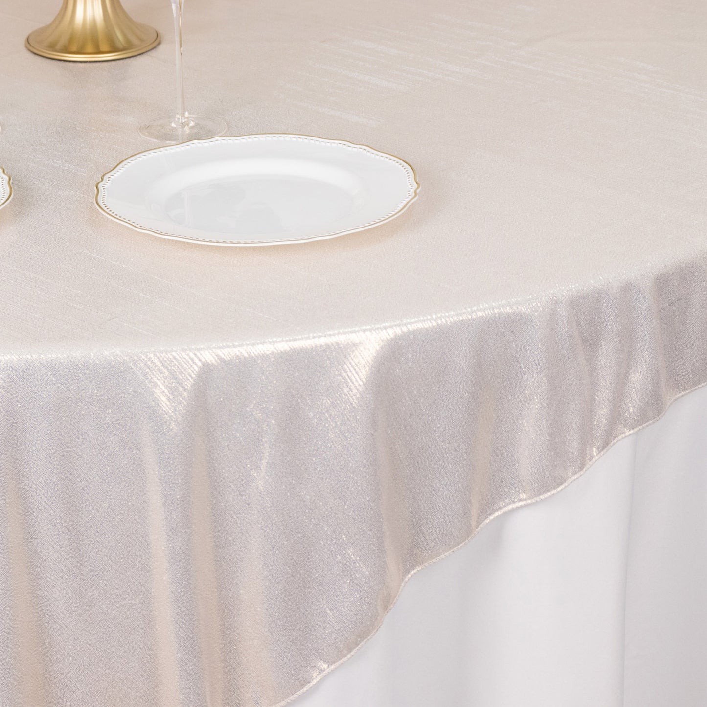 Beige shimmer sequin dots table overlay on a table setting.