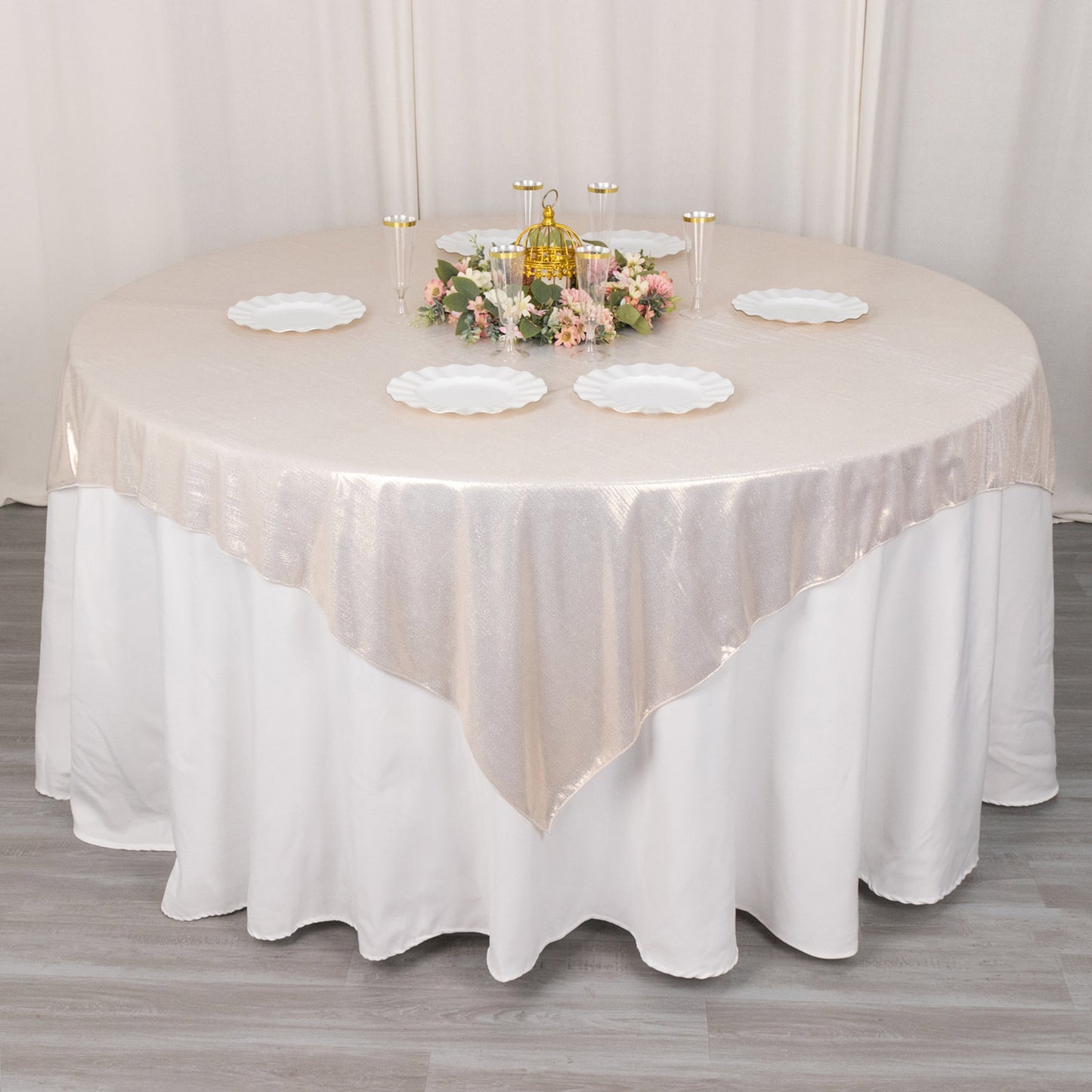 Beige shimmer sequin dots square table overlay on a round table.