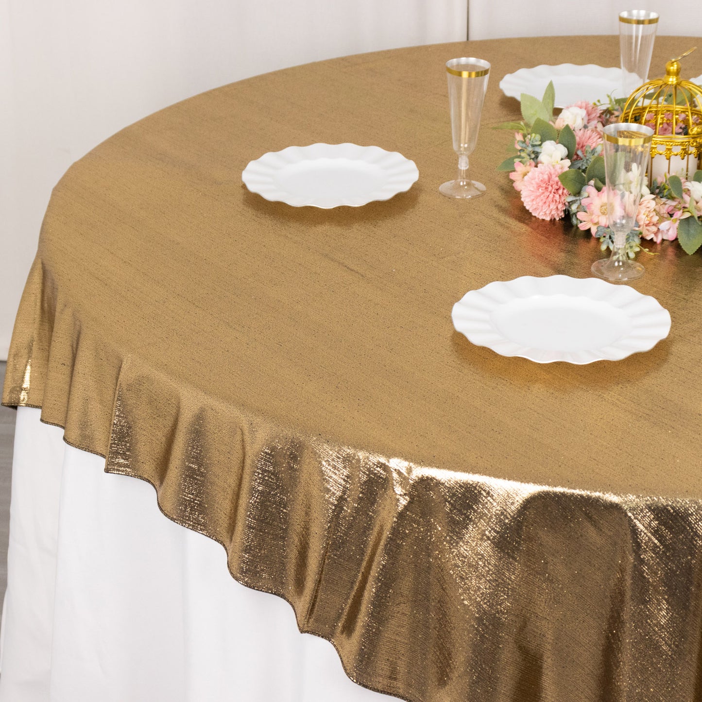 Antique gold shimmer sequin table overlay on a round table.