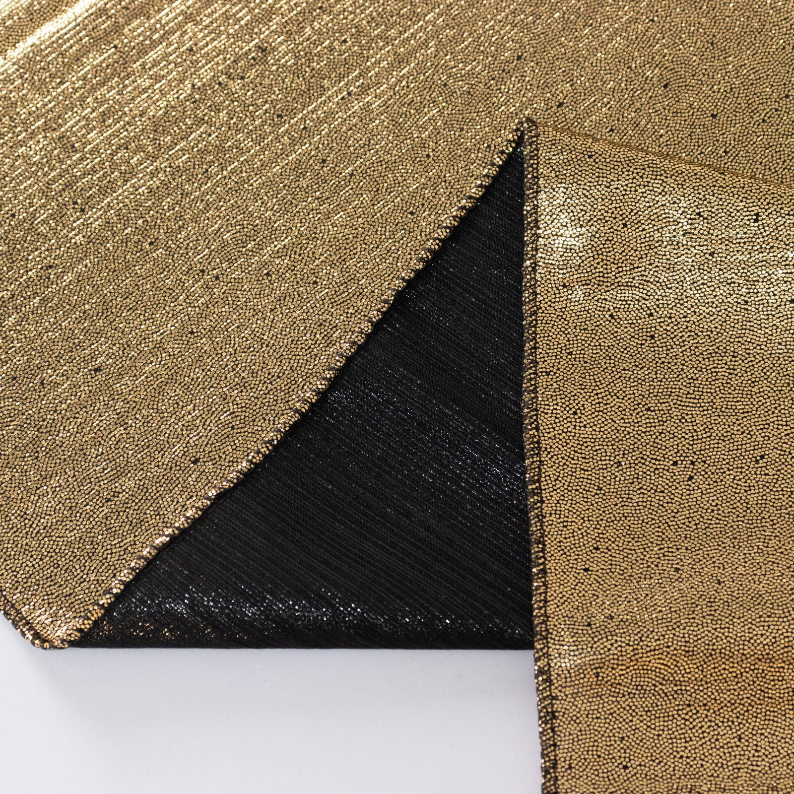 Antique gold sequin table overlay with a shimmer finish.