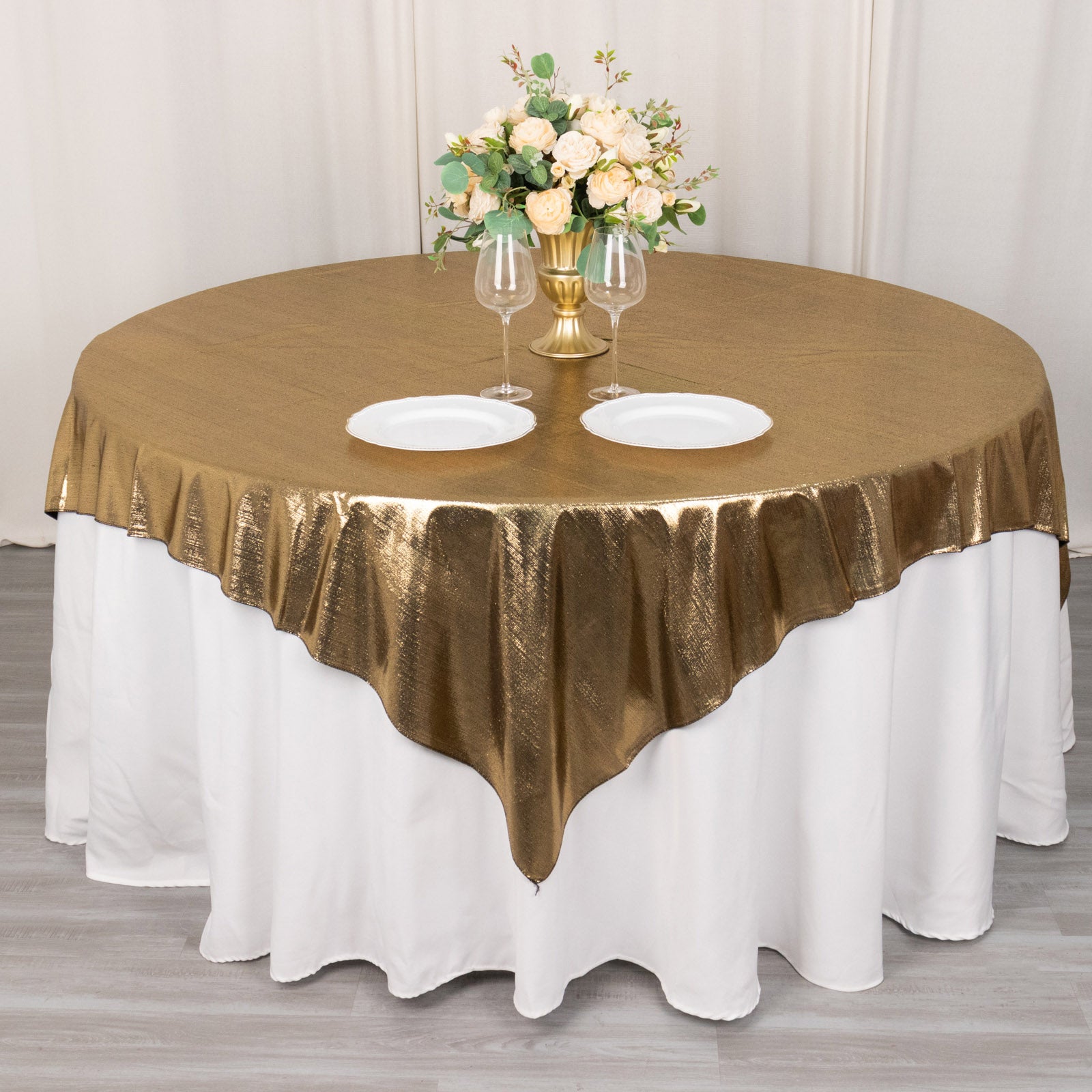 Antique gold shimmer sequin dots table overlay on a round table.