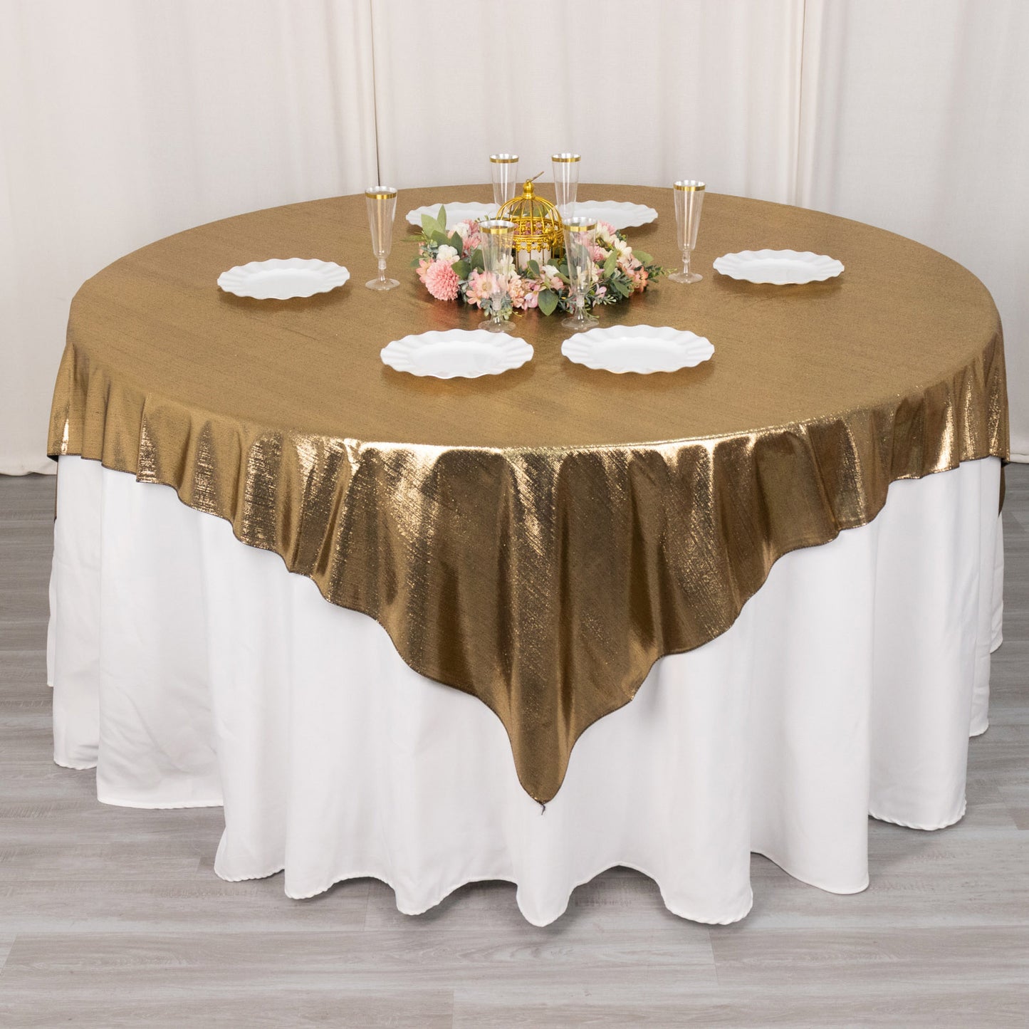 Antique gold shimmer sequin table overlay on a round table.