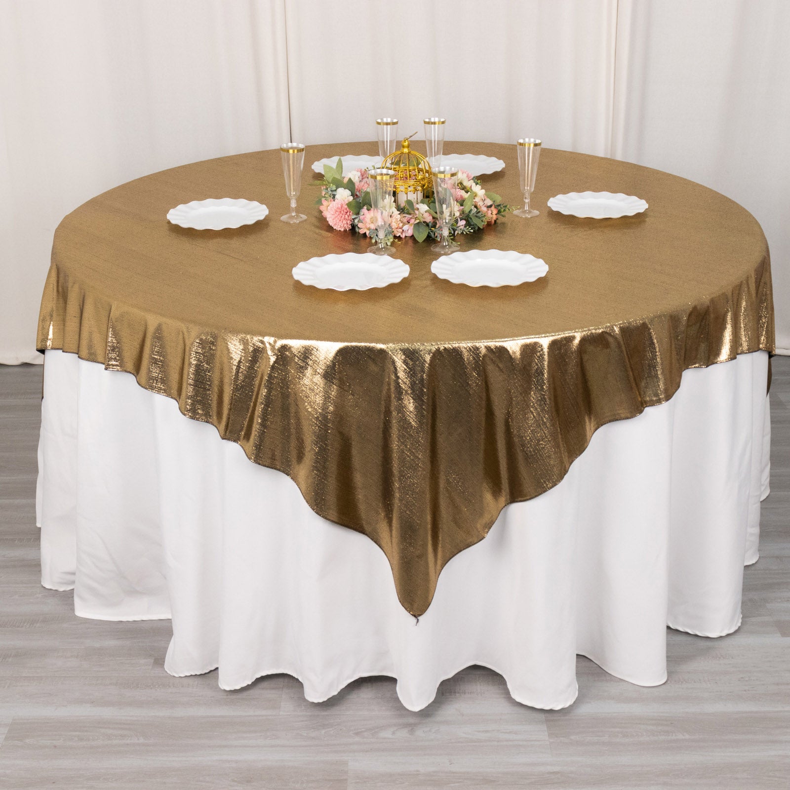 Antique gold shimmer sequin table overlay on a round table.