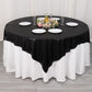 Black shimmer sequin dots table overlay on a round table with floral centerpiece.