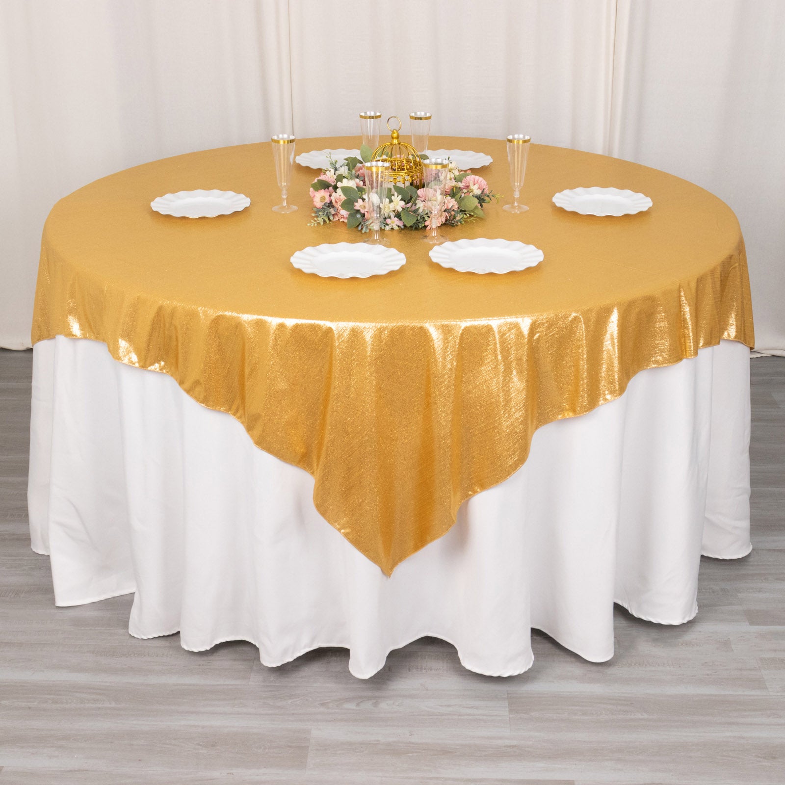 Gold shimmer sequin dots table overlay on round table with white accents.