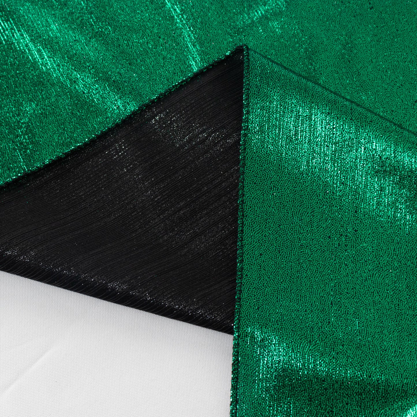 Hunter emerald green shimmer sequin table overlay with black edges.