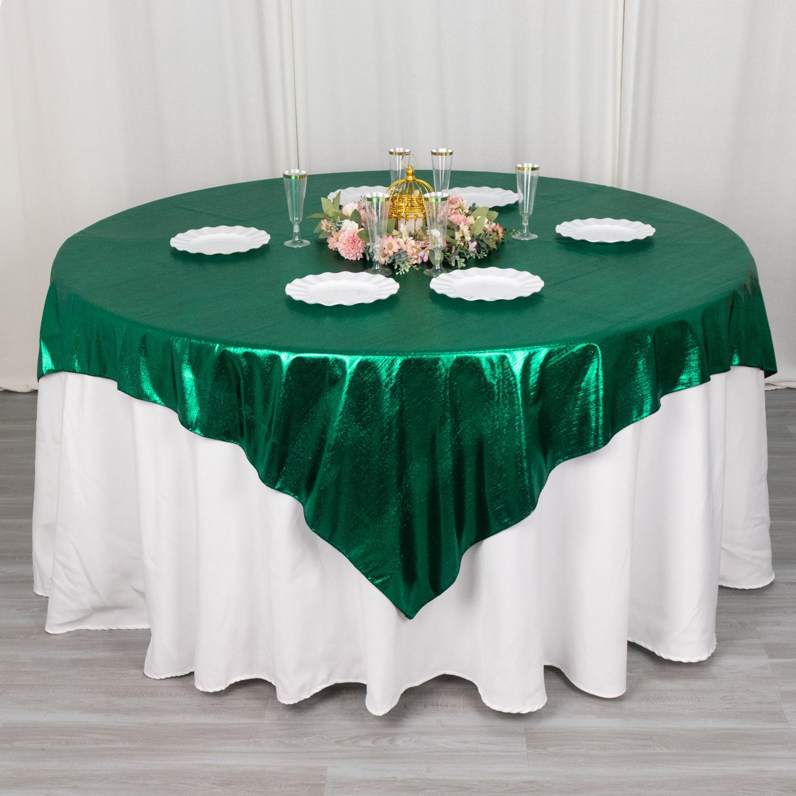 72"x72" Hunter Emerald Green Shimmer Sequin Dots Table Overlay on a round table.