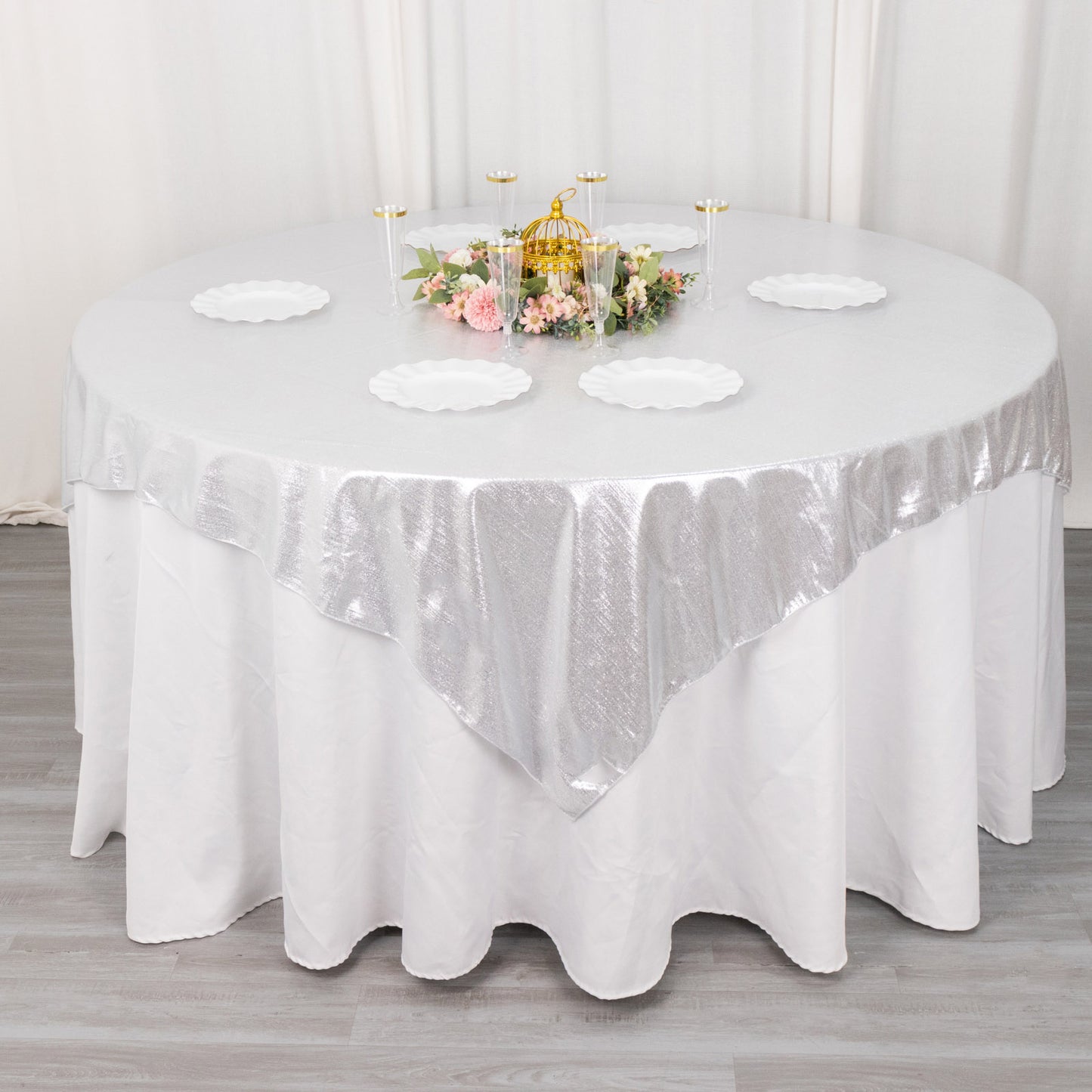 Silver shimmer sequin dots table overlay on a round table.