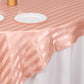 Dusty rose satin stripe table overlay on an elegant table setting.