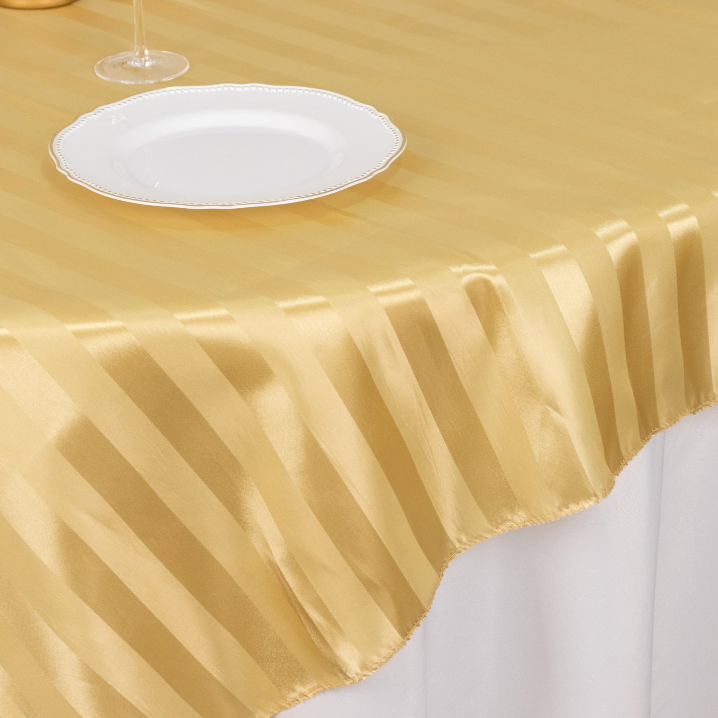 Champagne satin stripe table overlay, smooth elegant table topper.