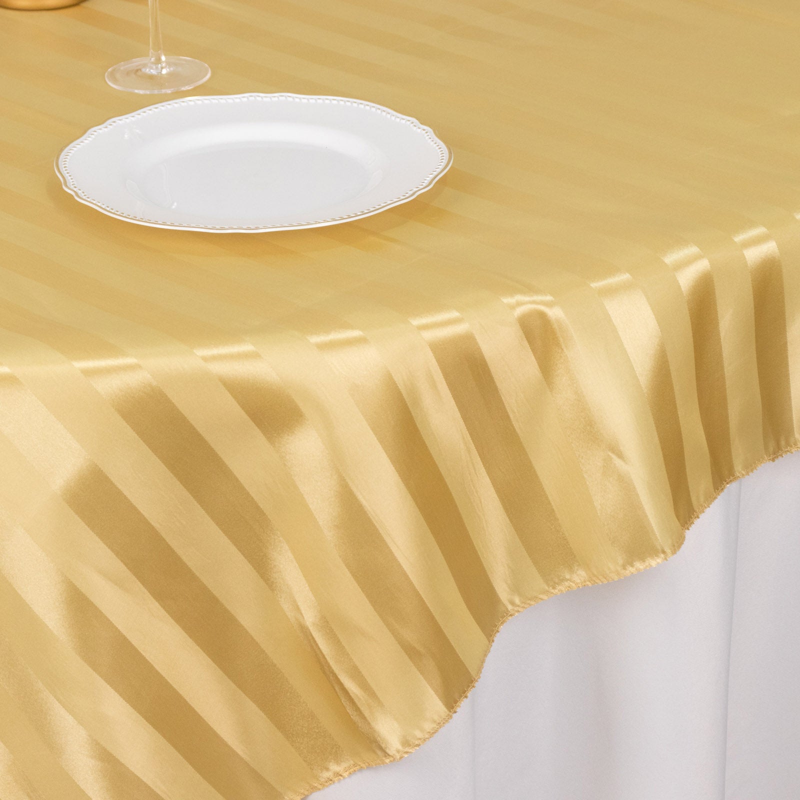 Champagne satin stripe table overlay, smooth elegant table topper.