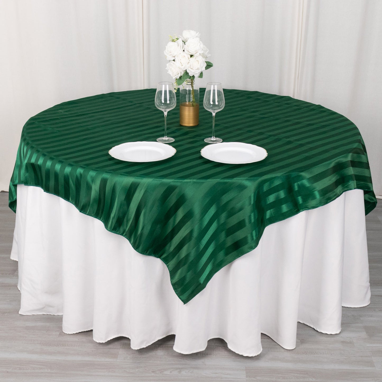 72"x72" Hunter Emerald Green Satin Stripe Table Overlay on a round table.