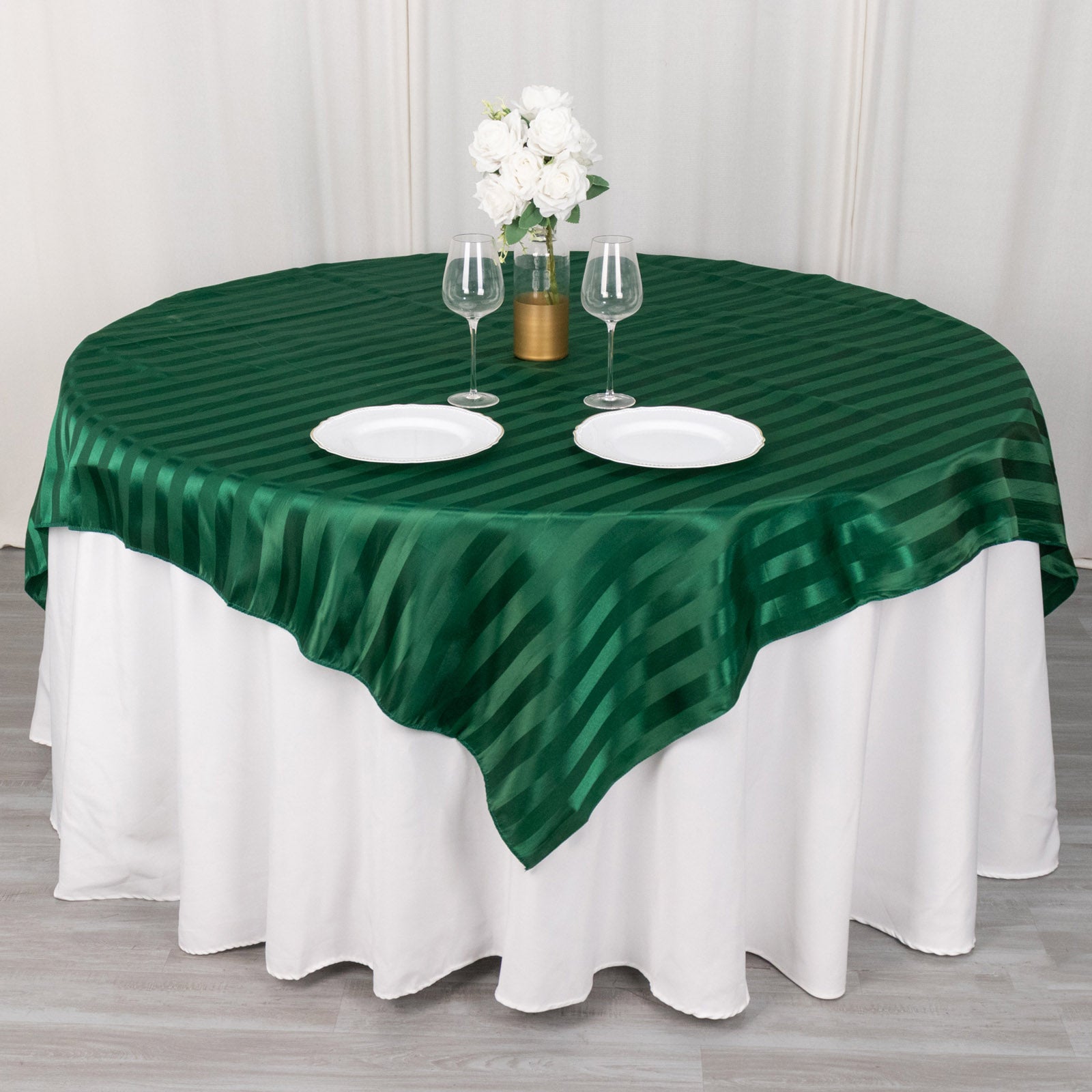 72"x72" Hunter Emerald Green Satin Stripe Table Overlay on a round table.