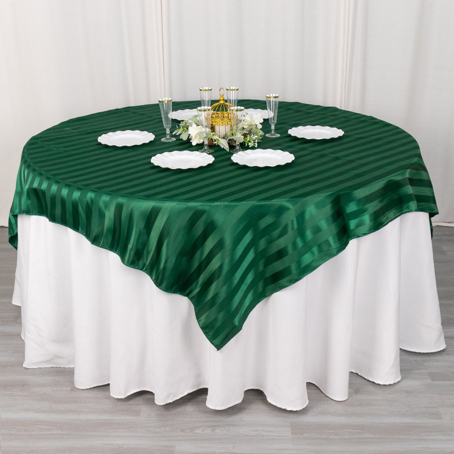 72"x72" Hunter Emerald Green Satin Stripe Table Overlay on a round table.