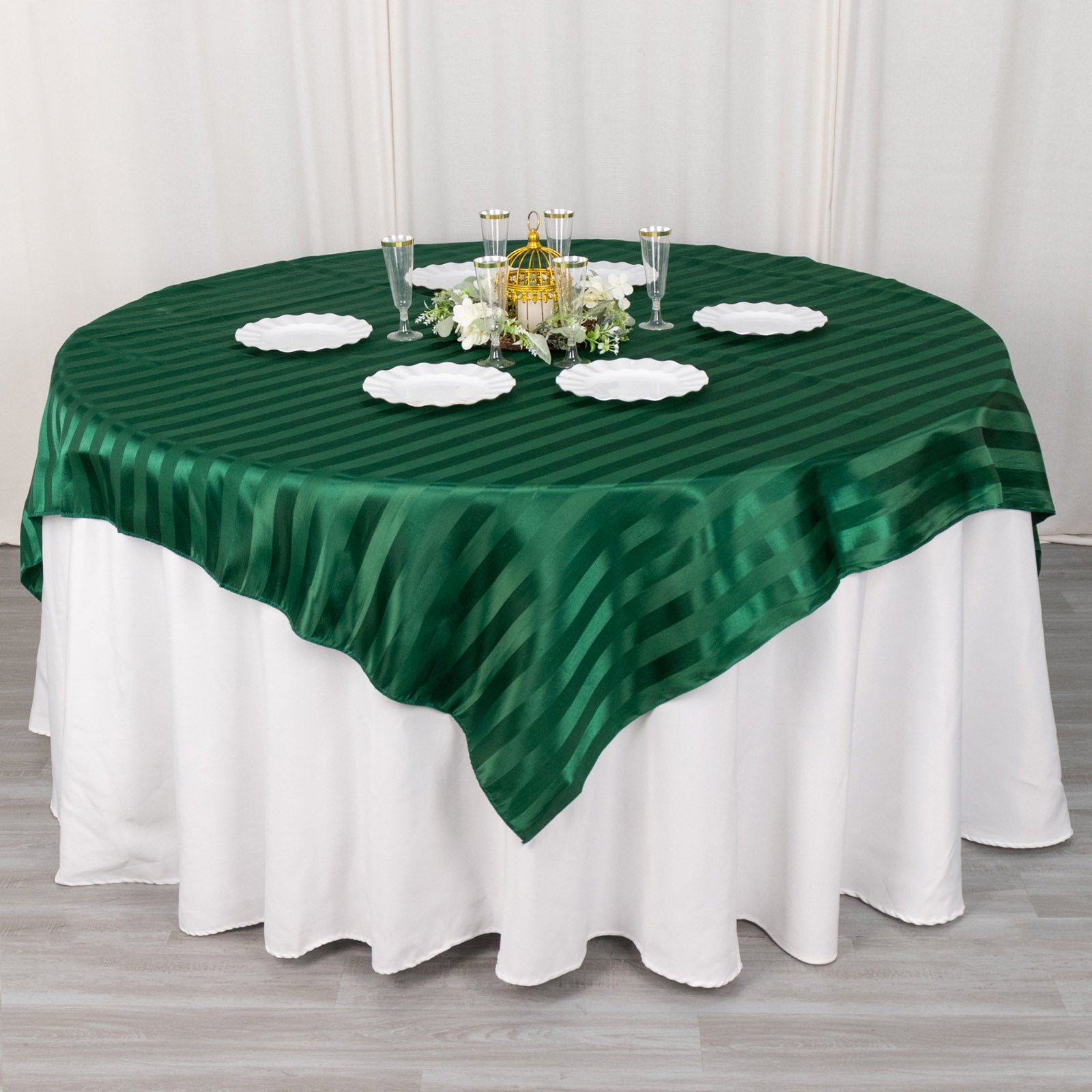 72"x72" Hunter Emerald Green Satin Stripe Table Overlay on a round table.