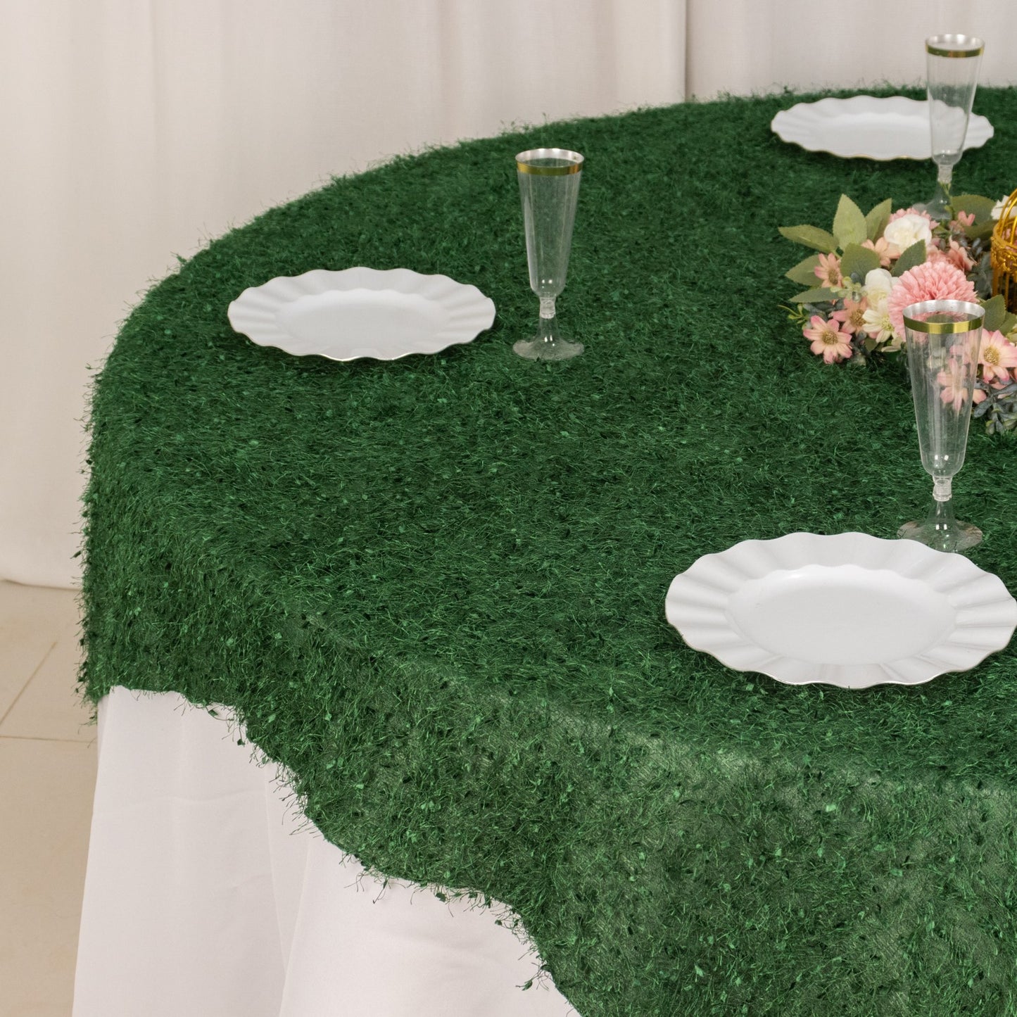 Green fringe shag square polyester table overlay on a round table.