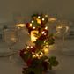 Red silk rose flower garland with warm white LED lights.