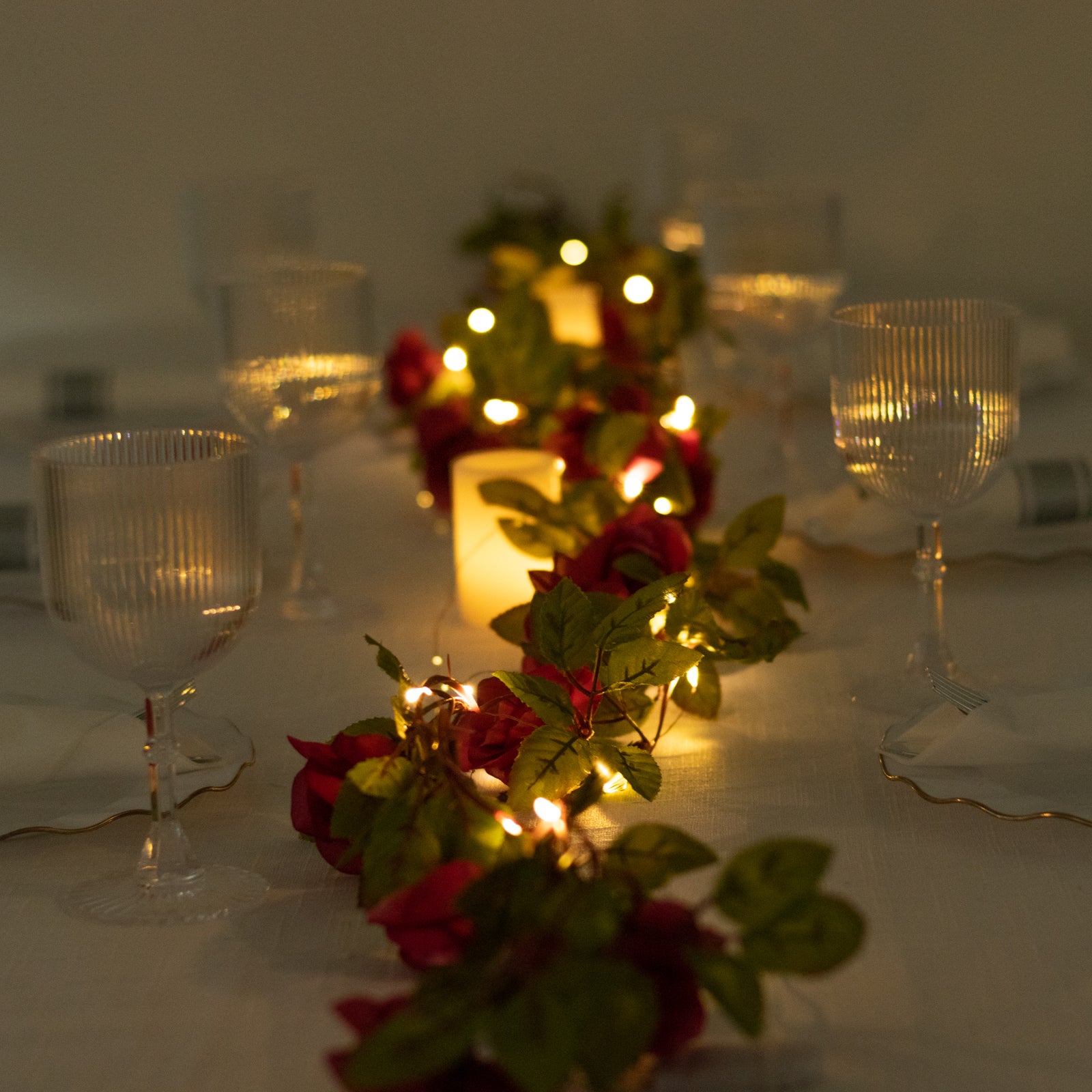 Red silk rose flower garland with warm white LED lights.