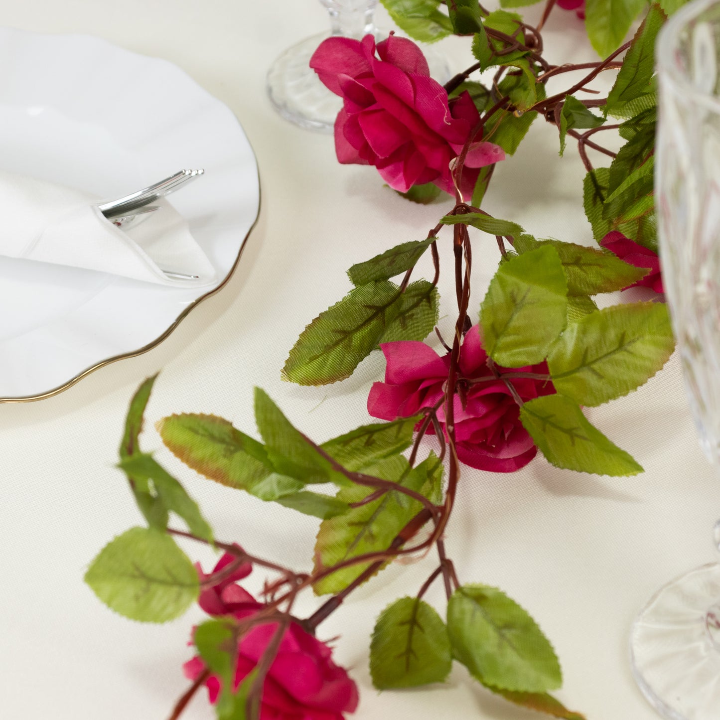 Red silk rose flower garland vine string lights with warm white LEDs.