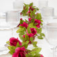 Red silk rose flower garland vine string lights on a table setting.