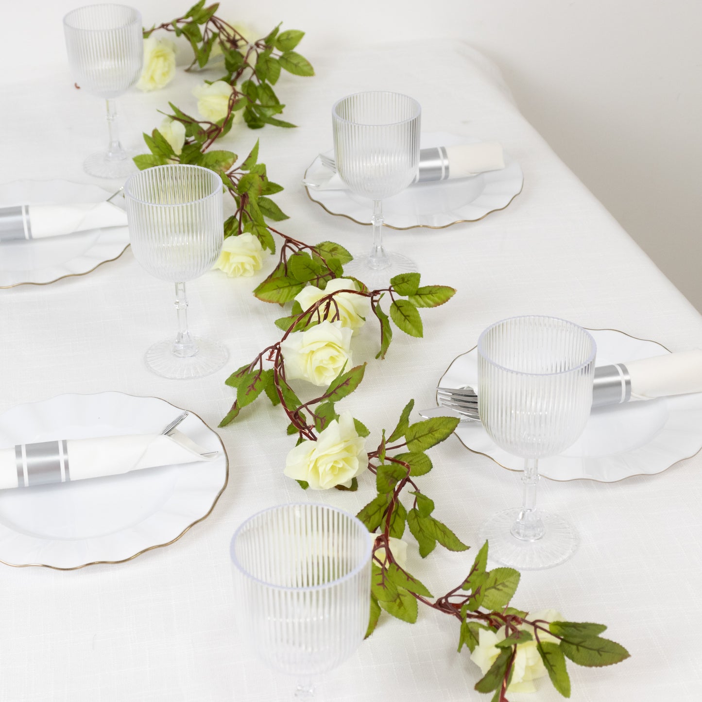 Warm white rose flower garland string lights on a table setting.