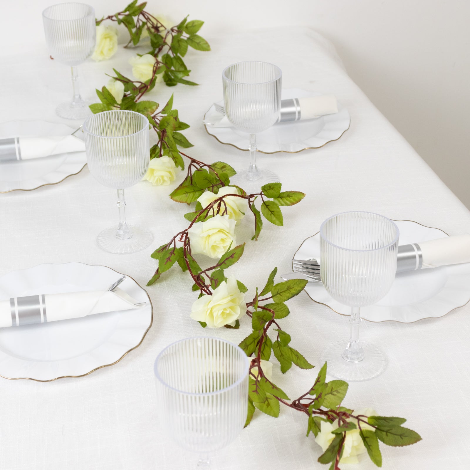 Warm white rose flower garland string lights on a table setting.