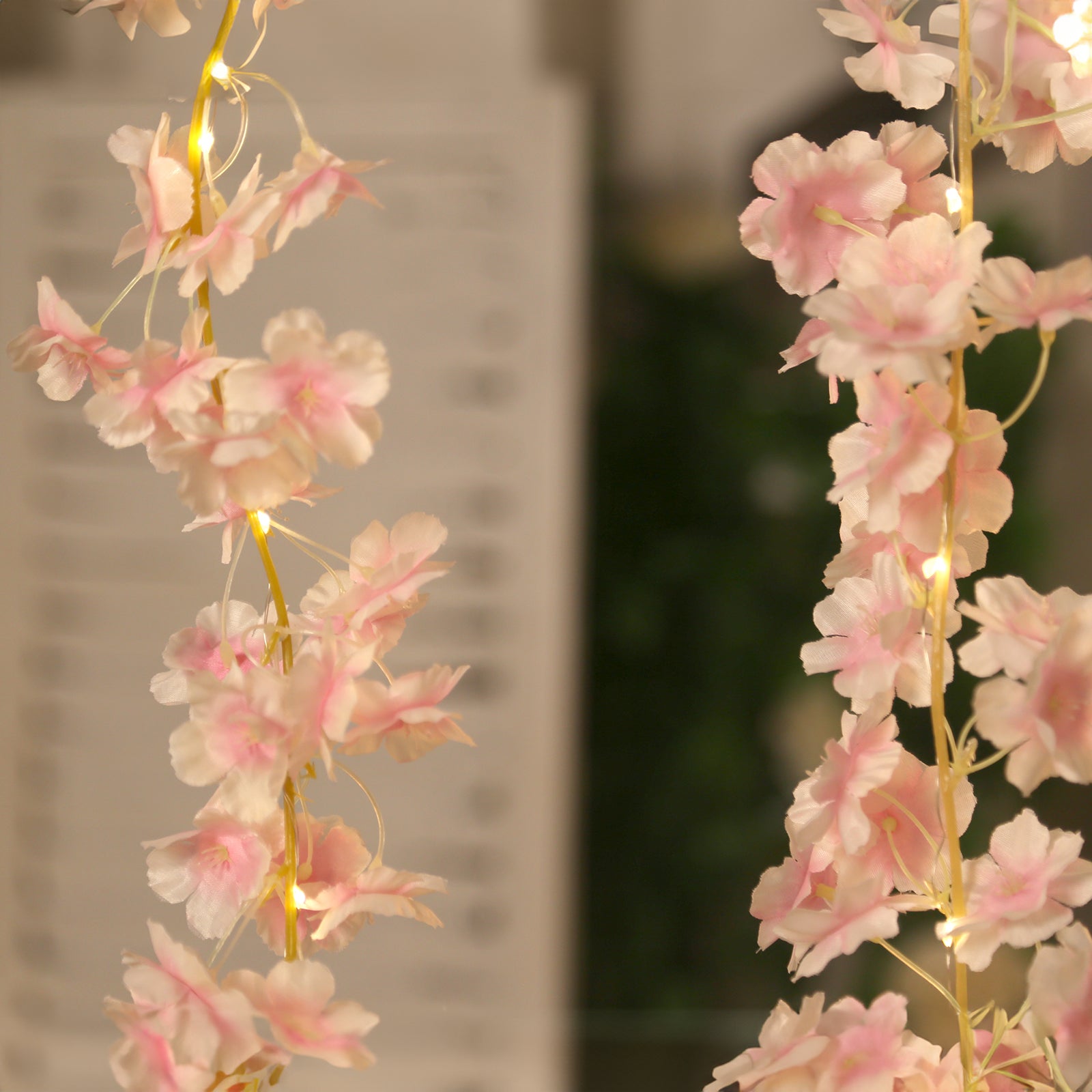 Blush artificial cherry blossom garland with warm white LED lights.