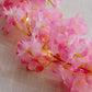 Pink cherry blossom fairy string lights with warm white LEDs.