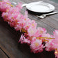 Pink cherry blossom fairy string lights on a wooden table.